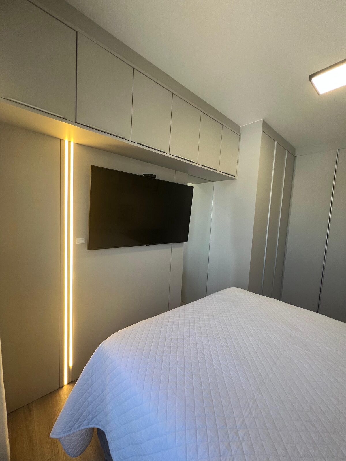 Dormitório com armários aéreos e LED